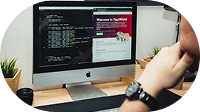 A developer writing code on a desktop monitor